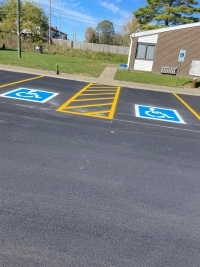 Repainted handicap parking places in front of a building.